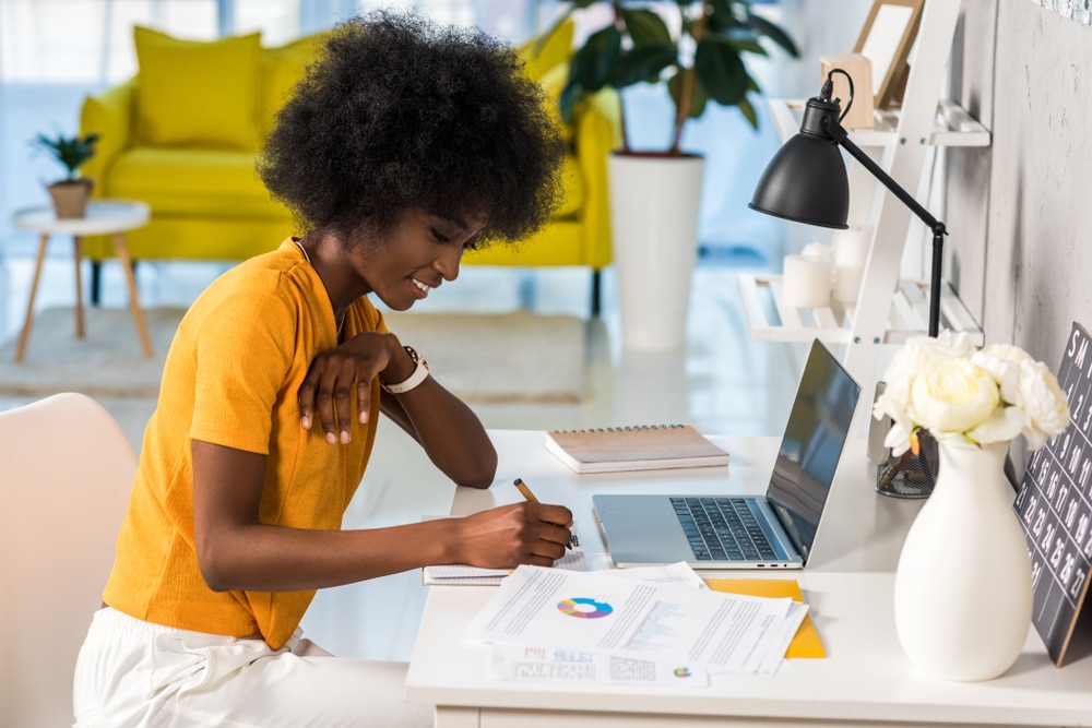 side view of smiling woman freelancer working at home